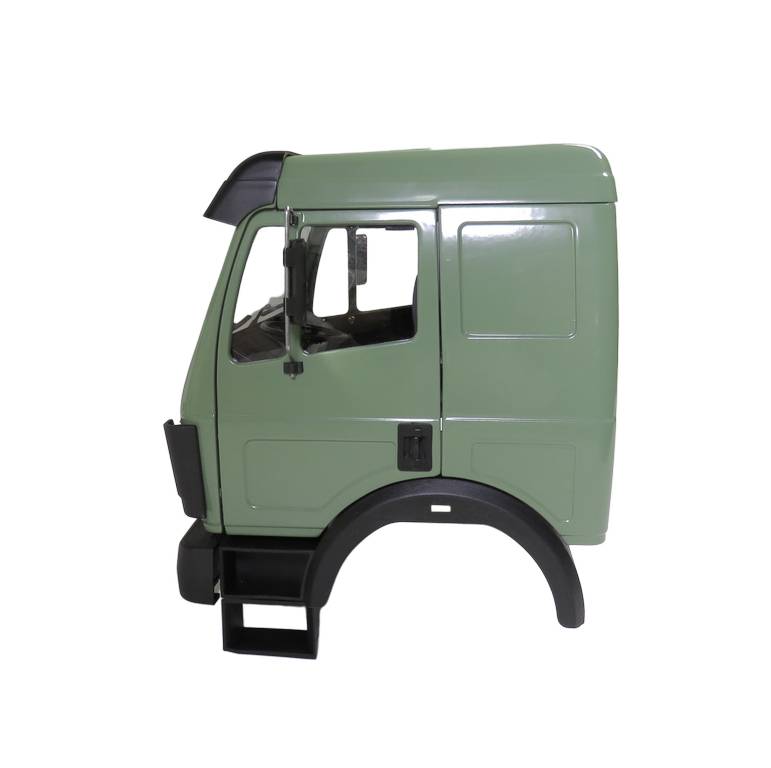 Grünes Modell einer Lkw-Kabine, Seitenansicht, ohne Motorhaube oder Räder.