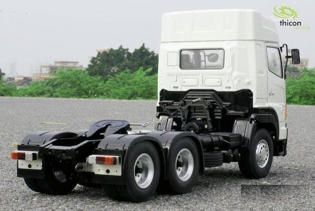 Lkw auf freiem Gelände, hinten zu sehen, mit grünem Wald im Hintergrund. Gezeigt wird das Chassis ohne Anhänger.