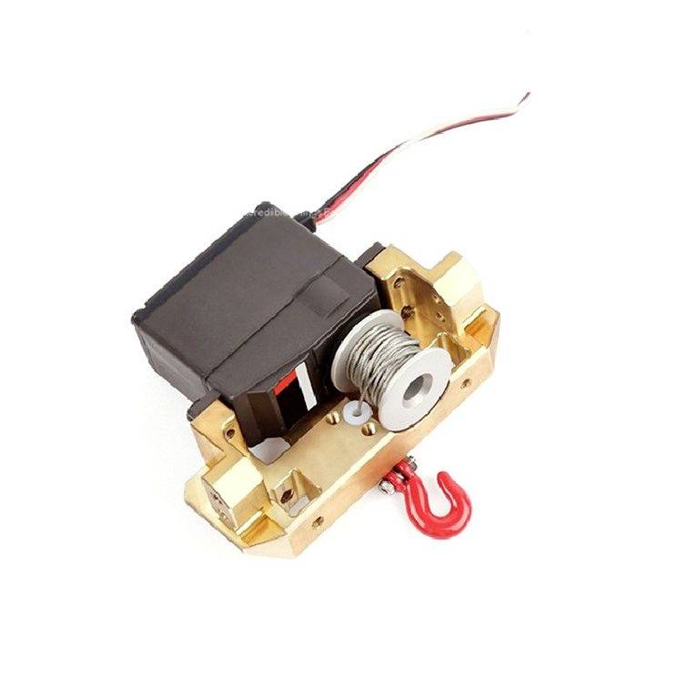 Ein kleiner elektrischer Motor mit Kabeln, einer Metallrolle und einem roten Haken, geeignet für Modellbauprojekte.