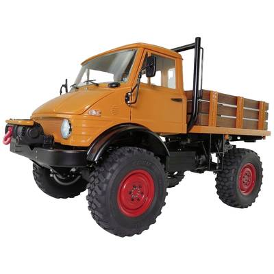 Orangefarbenes Nutzfahrzeug mit großer Bodenfreiheit und roten Felgen, geeignet für den Einsatz in unwegsamem Gelände.
