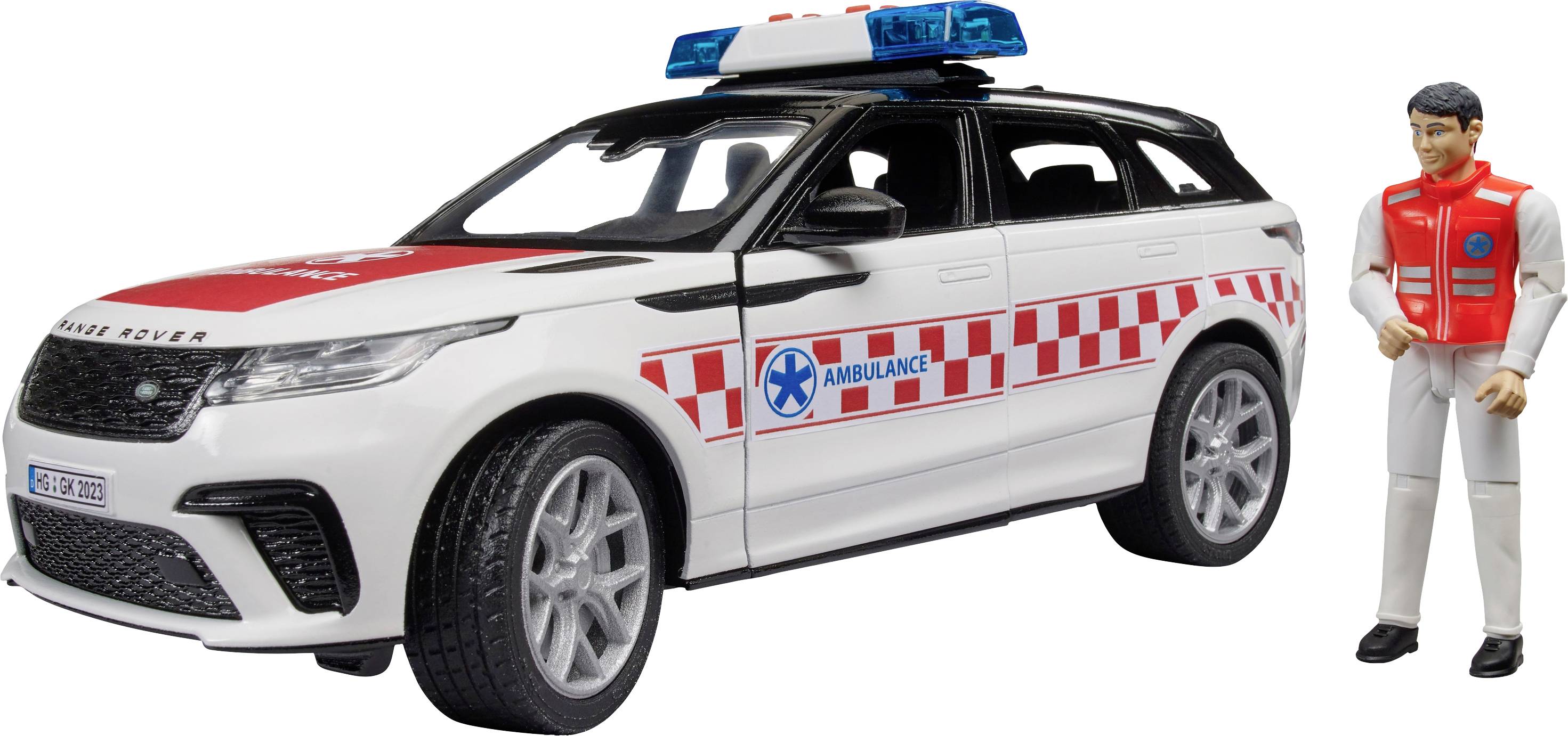 Ein weißes Modellauto der Marke 'Range Rover' mit 'Ambulance'-Aufkleber und blauem Licht steht neben einer männlichen Spielfigur.