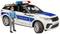 Spielzeug-Polizeiauto mit blauen Markierungen und Blaulicht auf dem Dach, daneben eine Spielfigur in blauer Uniform.