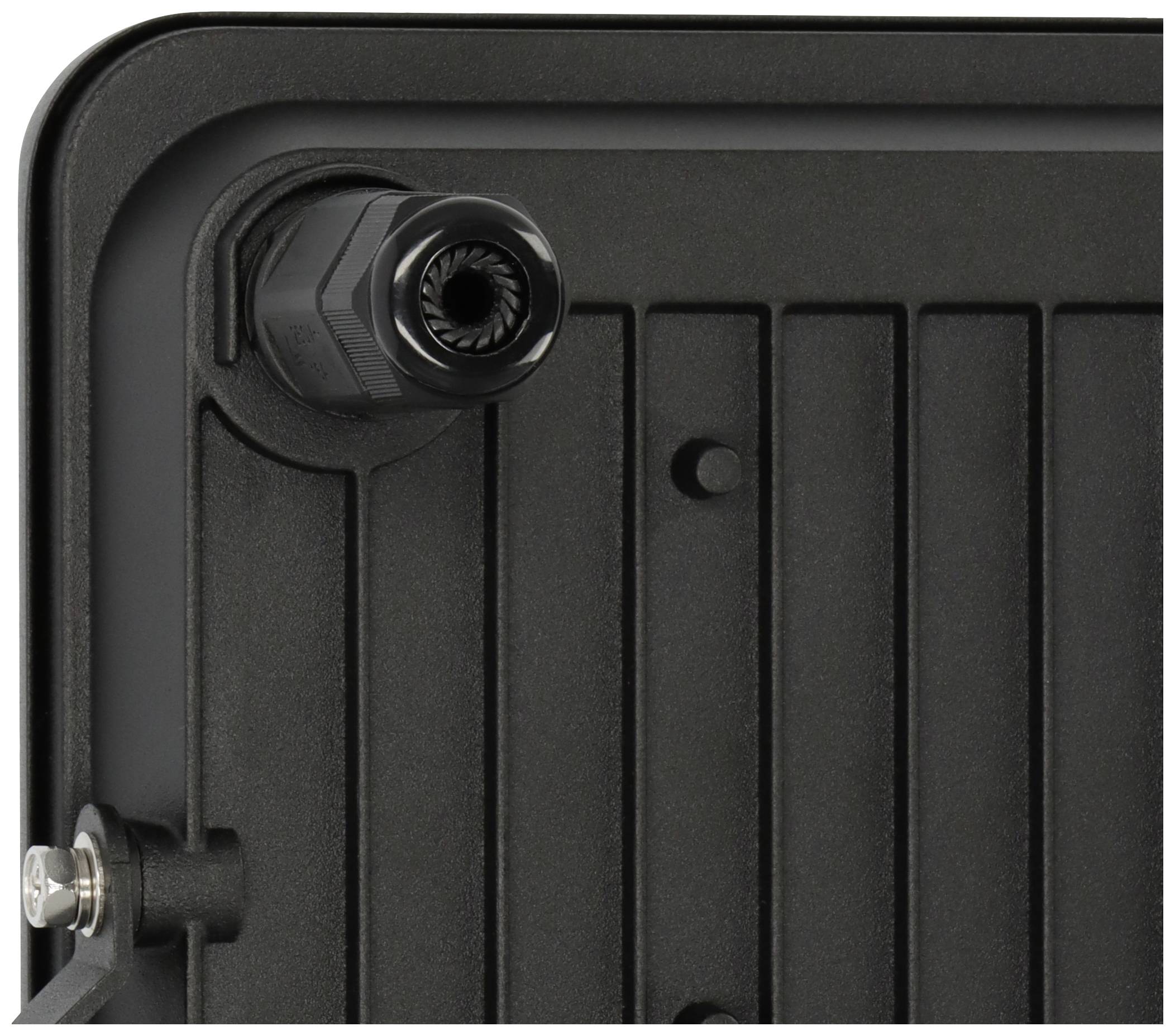 Nahaufnahme einer schwarzen, strukturierten Oberfläche mit einer Befestigungsschraube und einer kabelähnlichen Verbindung in der oberen Ecke.