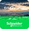 'Schneider Electric EcoStruxure' Logo über Stadtlandschaft bei Sonnenuntergang.