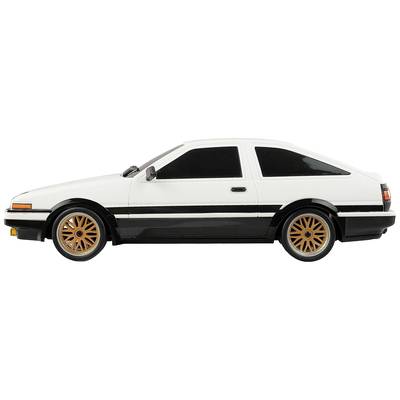 Ein weiß-schwarzes Modellauto im Profil mit orangefarbenen Felgen, das ein älteres, sportliches Autodesign repräsentiert.