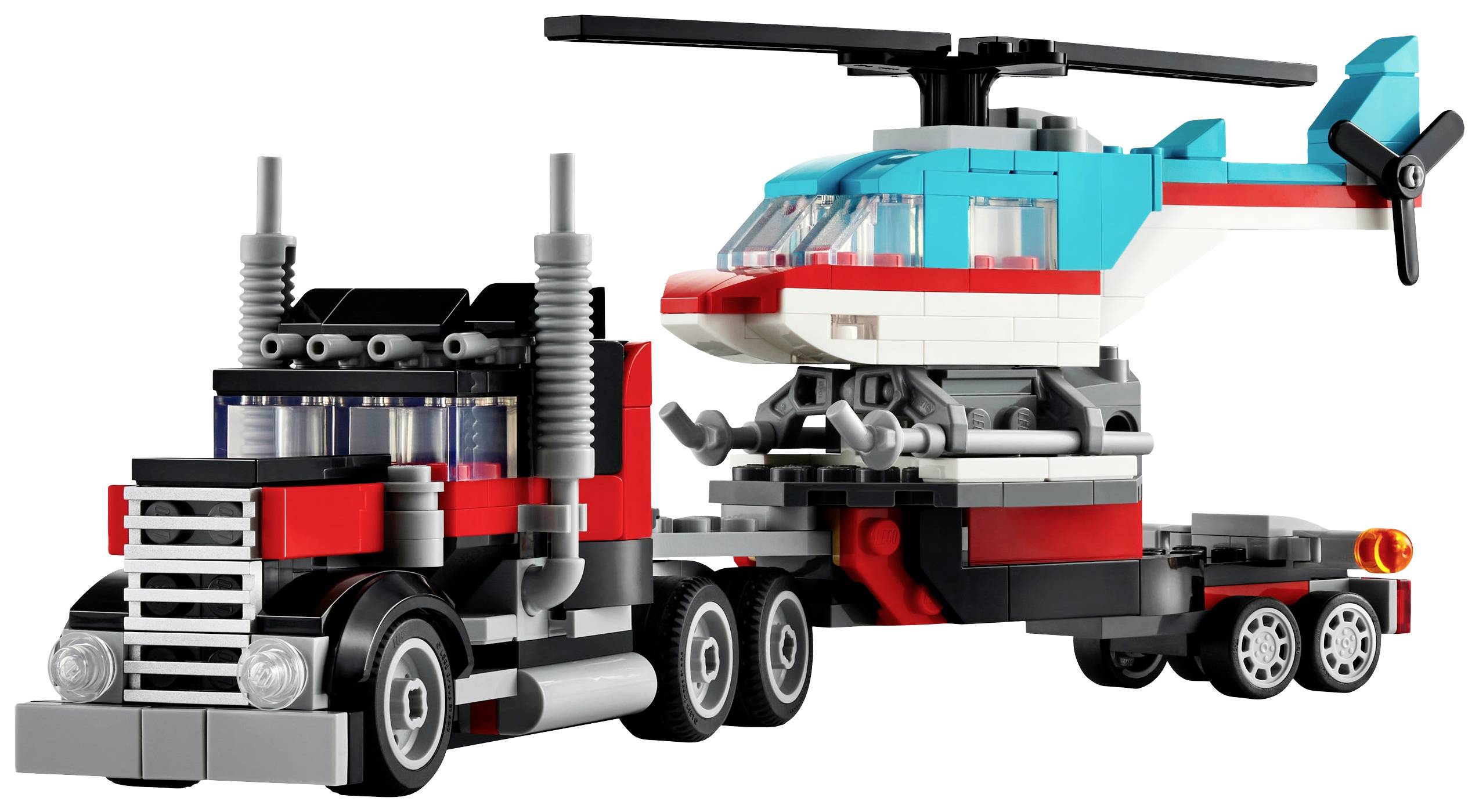Ein Lego-Set zeigt einen roten Lastwagen mit Auflieger, der einen blauen Hubschrauber transportiert.