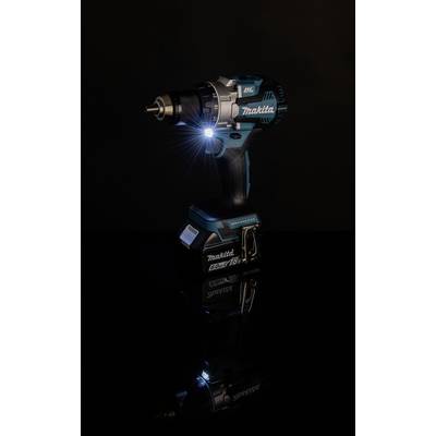 Akkubohrschrauber mit LED-Licht leuchtet auf dunkler Oberfläche, Marke sichtbar, für Handwerksarbeiten geeignet.