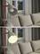 Eine Stehlampe neben einem grauen Sofa. Oben ist die Lampe aus, unten ist sie eingeschaltet und leuchtet den Raum aus. Fenster im Hintergrund.