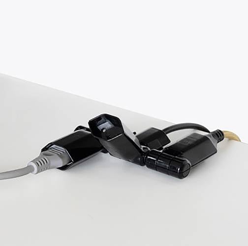 Mehrere schwarze und graue Kabelstecker nebeneinander auf weißem Hintergrund.