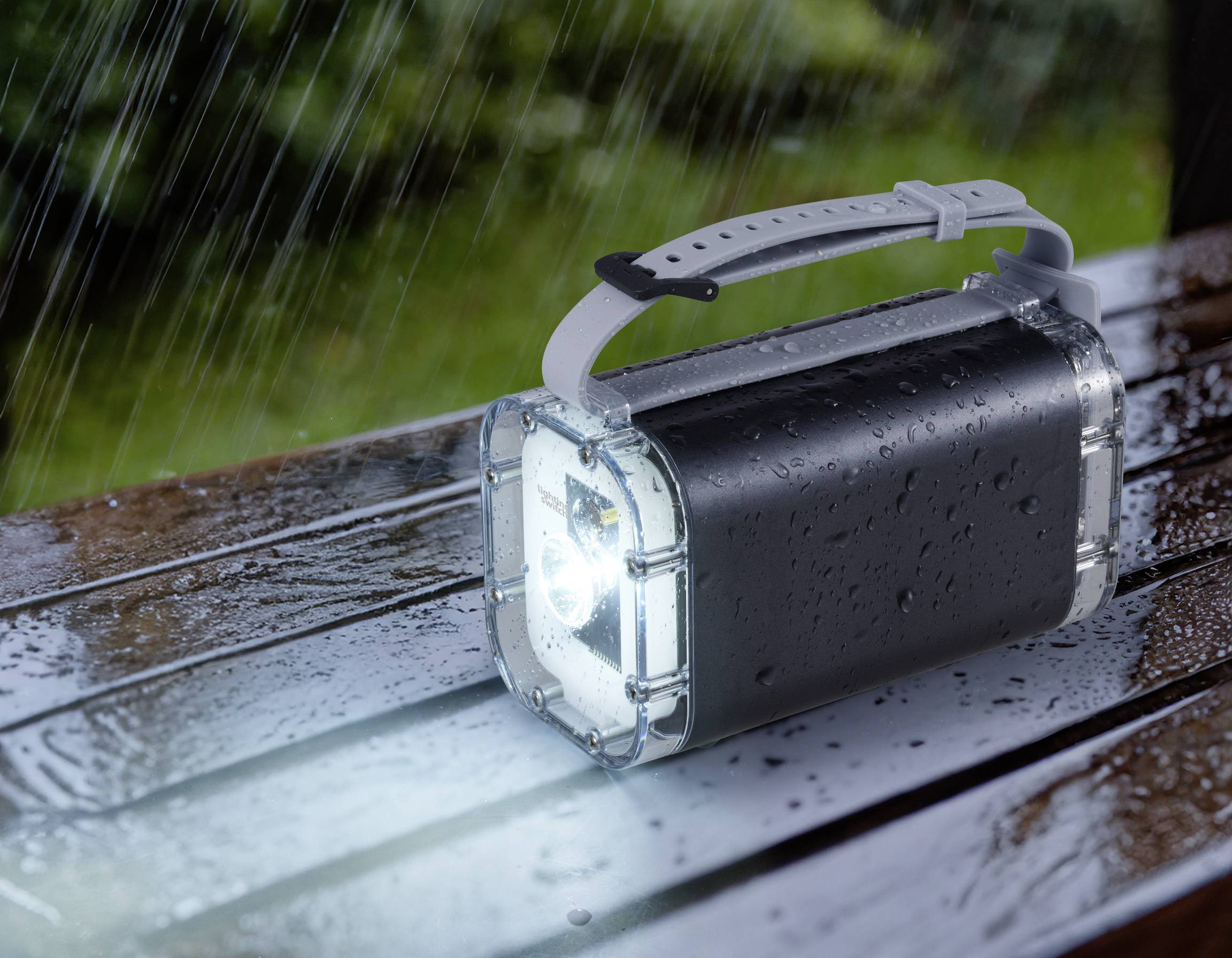 Eine wasserdichte Taschenlampe leuchtet bei Regenwetter auf einer nassen Parkbank und symbolisiert Widerstandsfähigkeit.