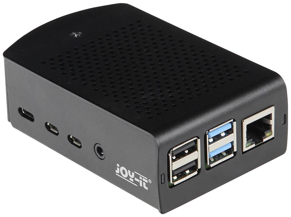 Kleiner schwarzer Computer mit mehreren USB-Anschlüssen, einem Netzanschluss und Belüftungsschlitzen, auf einem Tisch platziert.