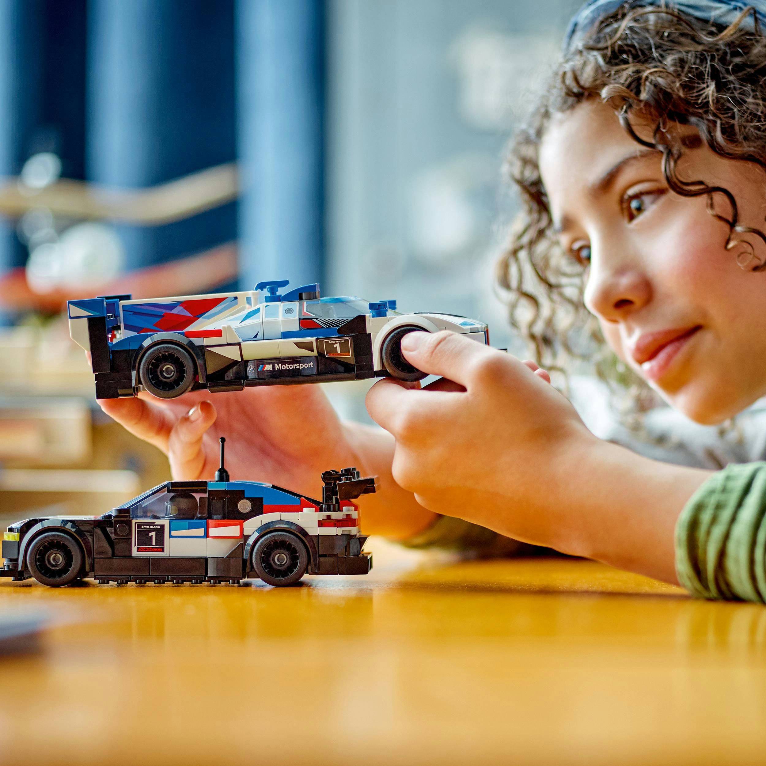 Ein Kind spielt konzentriert mit zwei kleinen Rennwagen-Modellen auf einem Tisch. Die Szene vermittelt Freude und Kreativität.