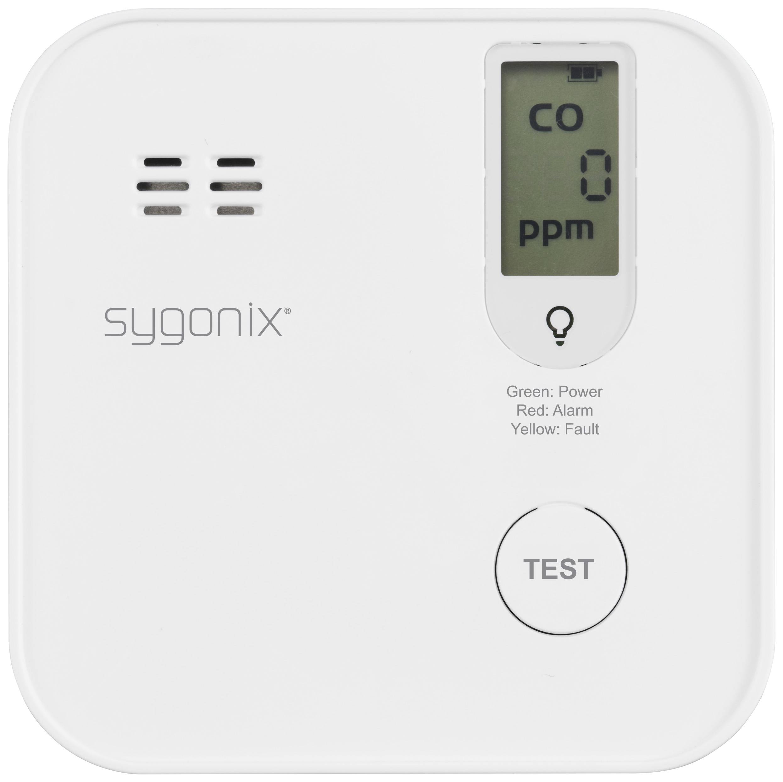 Ein Kohlenmonoxid-Melder mit digitalem Display zeigt '0 ppm'. Zwei Anzeigeleuchten: Grün für Betrieb, Rot für Alarm. Schaltfläche 'TEST'.