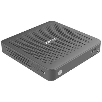 Ein kompakter, grauer Mini-PC mit Lüftungsschlitzen und einem USB-Anschluss an der Seite. Die Marke 'ZOTAC' ist oben abgebildet.