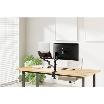 Ein moderner Schreibtisch mit Laptop und Monitor auf verstellbarem Halter, umgeben von natürlichem Licht und einer Pflanze.