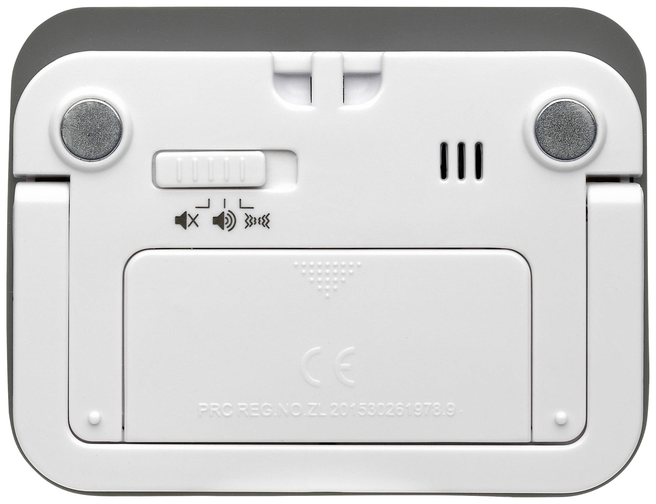 Die Rückseite eines elektronischen Geräts mit zwei Knöpfen, einem Schiebeschalter für Lautstärkeregler, einem Lautsprechergitter und einer Batterieabdeckung.