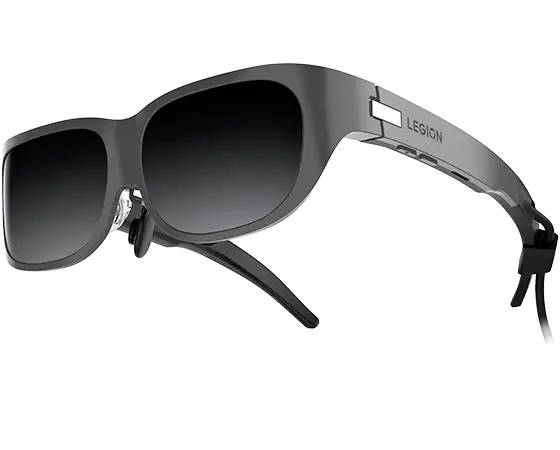 Eine schwarze Sonnenbrille mit dunklen Gläsern und einem Kabel an einem Bügel, auf dem der Schriftzug 'LEGION' steht.