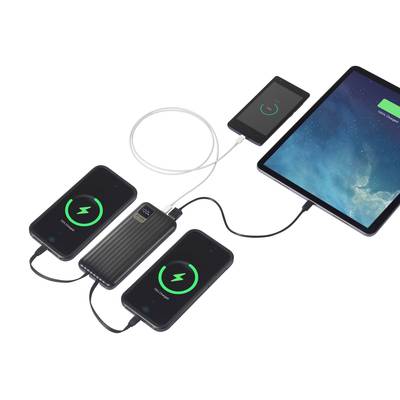 Ein Tablet und drei Smartphones werden gleichzeitig mit einem tragbaren Akku geladen, alle zeigen ein Ladesymbol auf ihren Bildschirmen.