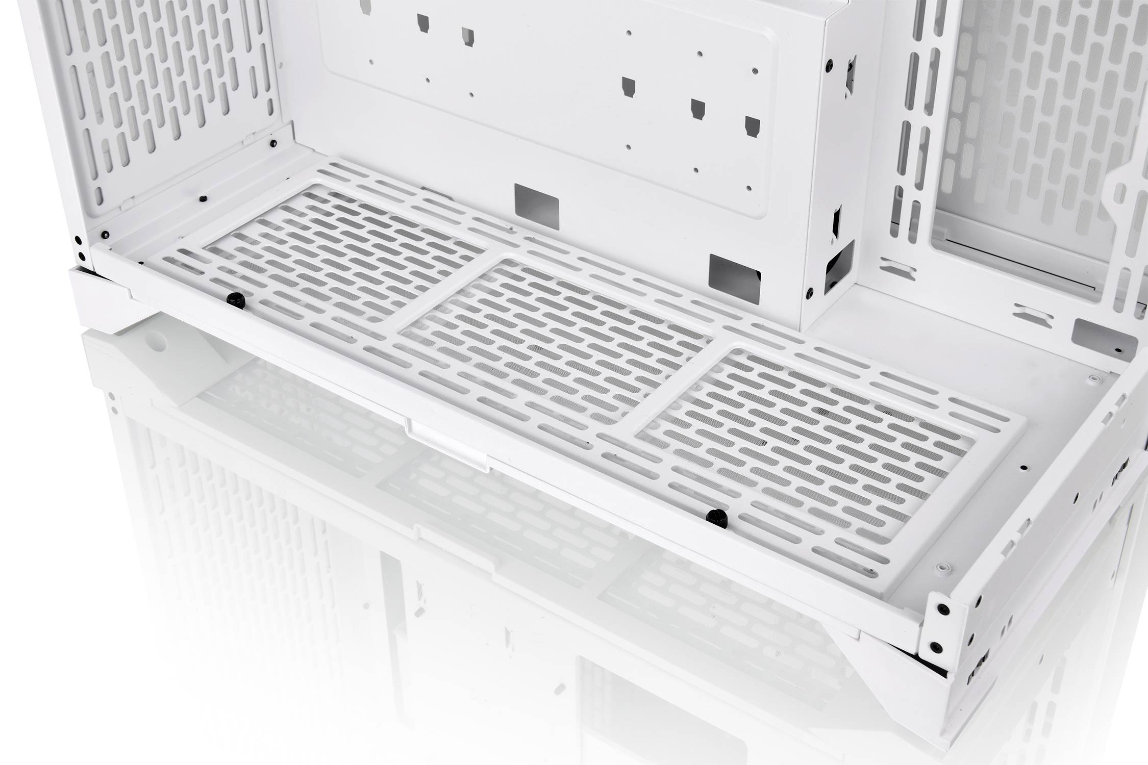 Innenansicht eines weißen Computergehäuses mit belüfteter Bodenplatte, zeigt Platz für Hardware-Komponenten und Kühlung.