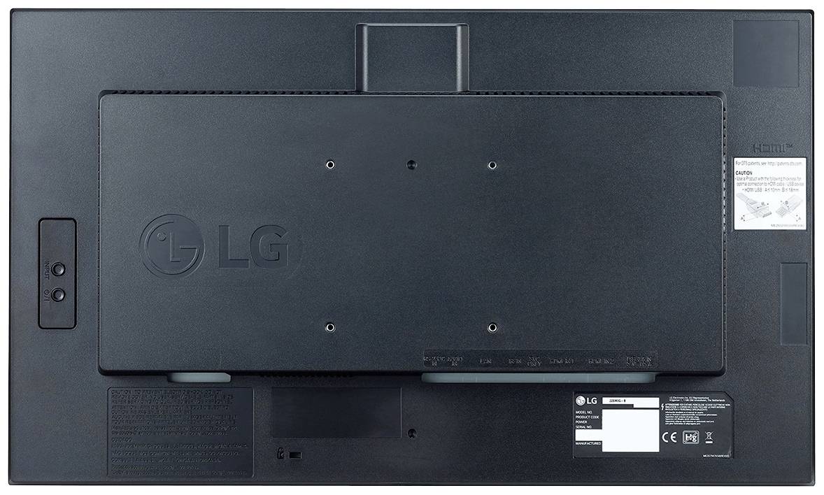 'Rückseite eines LG Monitors mit Wandhalterungsbefestigungen und Etiketten mit technischen Informationen und Sicherheits-Icons.'
