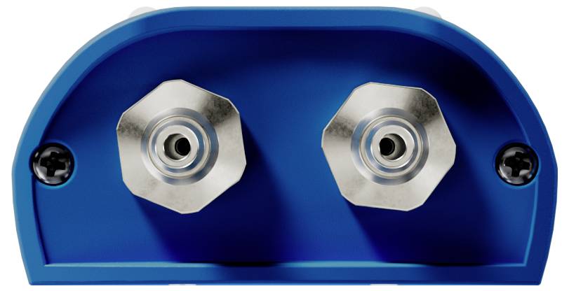 Nahaufnahme eines blauen Objekts mit zwei sechseckigen, metallischen Befestigungen, die wie Schrauben oder Anschlüsse auf einer flachen Oberfläche aussehen.