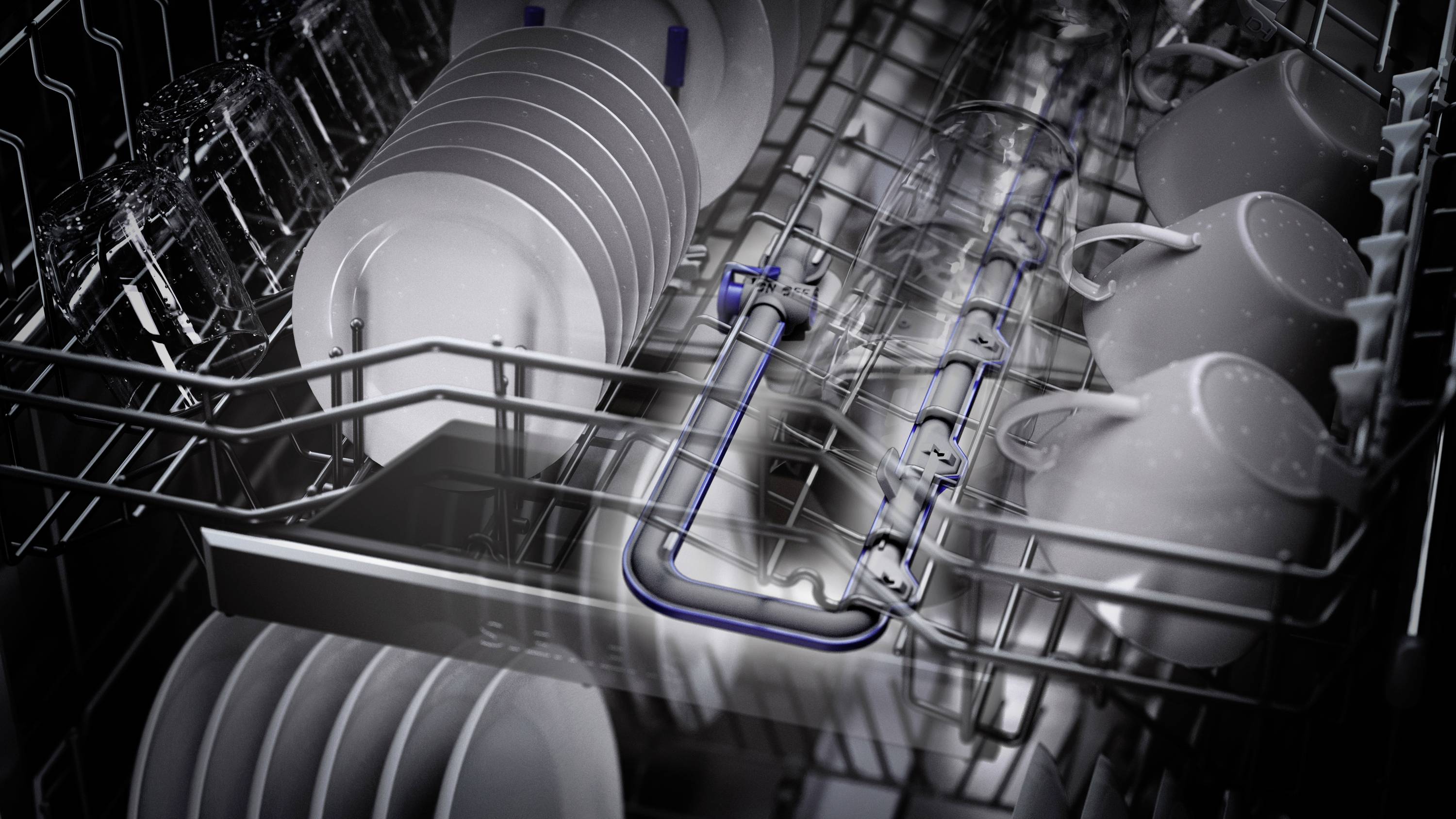 Ein Geschirrspülerkorb mit eingestapelten Tellern, Tassen und Gläsern, bereit für den Spülvorgang.