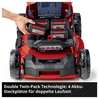 Akku-Rasenmäher mit vier Akku-Steckplätzen; eine Hand setzt einen Akku ein. Hinweis: 'Double Twin-Pack Technologie: 4 Akku-Steckplätze für doppelte Laufzeit'.<br>