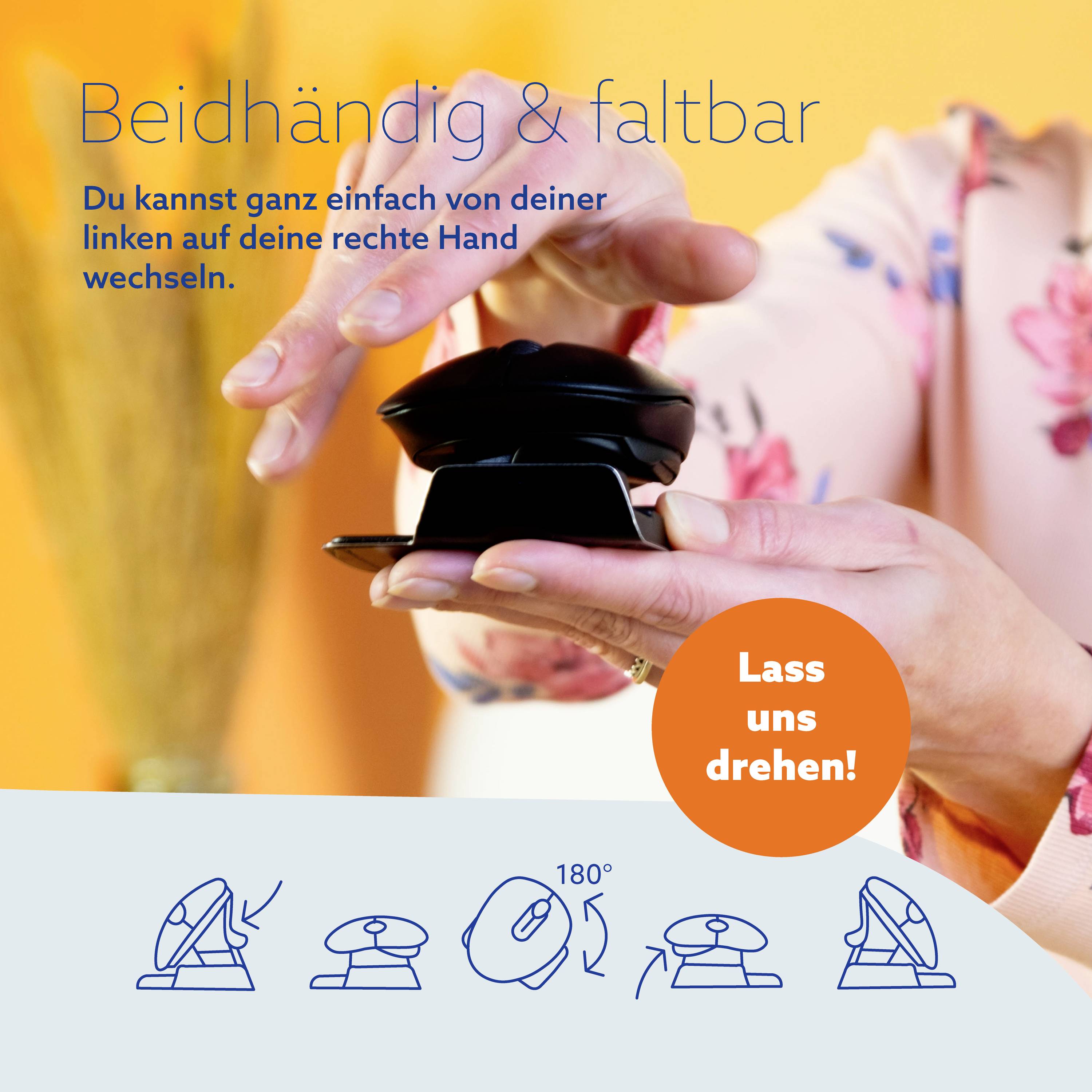 Eine Hand hält einen schwarzen, faltbaren Gegenstand. Ein orangefarbener Kreis mit 'Lass uns drehen!' ist zu sehen.