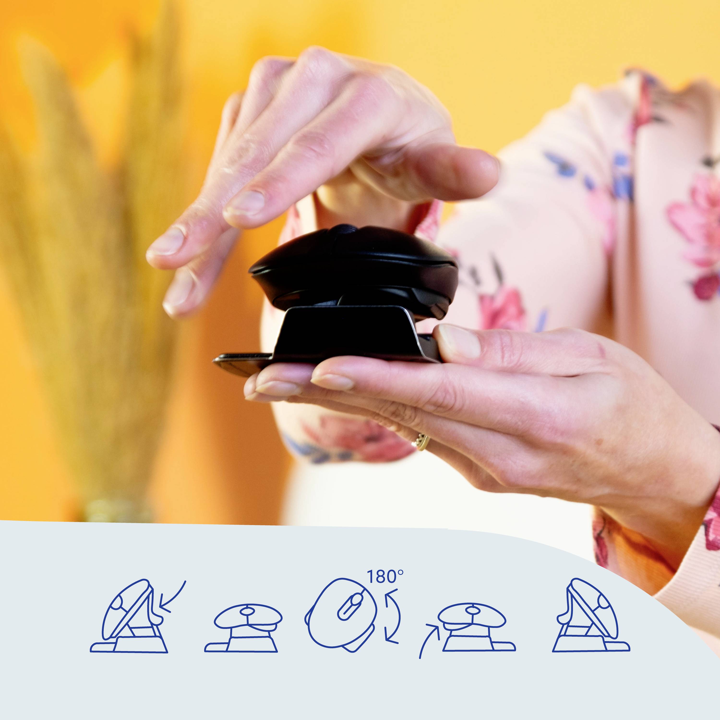 Person hält ein Gerät, das in der Mitte gedreht wird. Darunter eine Zeichnung, die das Drehen um 180 Grad zeigt.