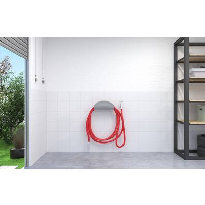Leerer Hauswirtschaftsraum mit einem roten Schlauch, der auf einem wandmontierten Halter aufgerollt ist, Fliesen-Spritzschutz, Betonboden, Fenster und Regalelement.