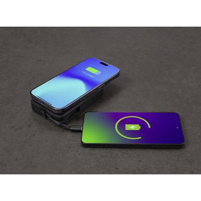 Zwei Smartphones auf einem Tisch; das linke Gerät wird über ein Kabel vom rechten aufgeladen.
