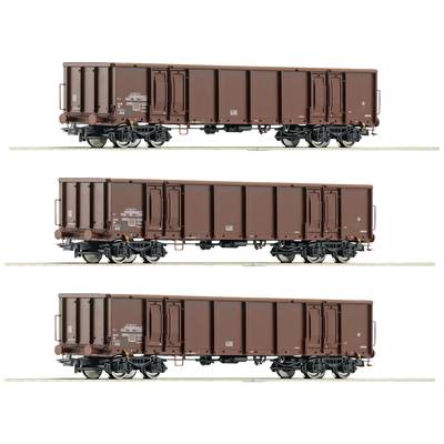 'Drei braune Güterwaggons auf Gleis in seitlicher Ansicht, identisch gestaltet, mit Beschriftungen und Details auf der Oberfläche.'