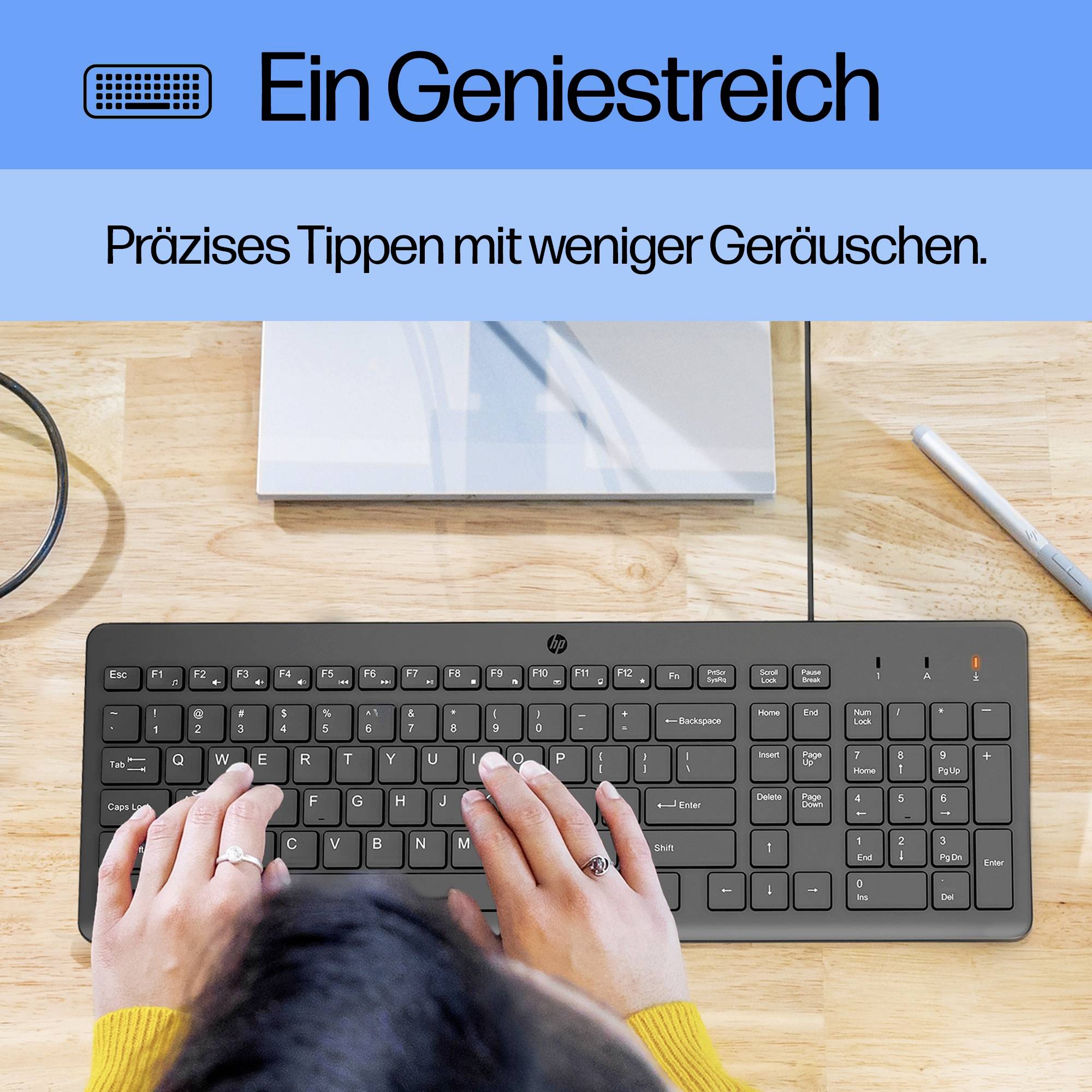 Eine Person tippt auf einer modernen Tastatur. Text im Bild: 'Ein Geniestreich. Präzises Tippen mit weniger Geräuschen.'