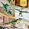 Ein Set aus drei Lego-Dinosauriern: ein Triceratops, ein Pterodactylus und ein T-Rex, alle in Grün- und Brauntönen dargestellt.