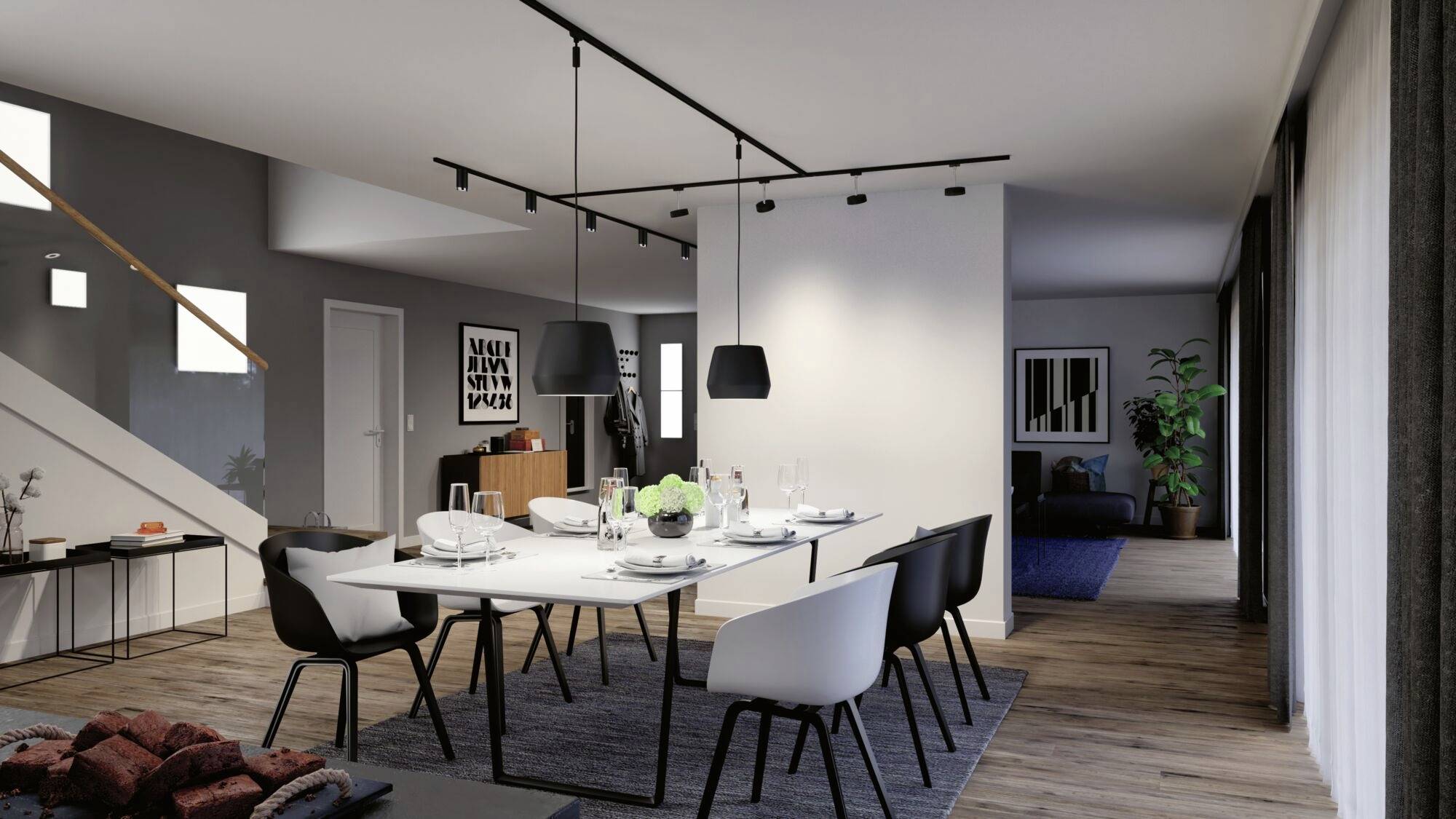 Ein modernes Esszimmer mit einem langen Tisch, weißen Stühlen und hängenden Lampen. Im Hintergrund ein Sideboard und Kunst an der Wand.