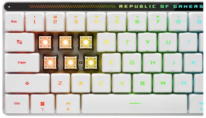 Weiße Gaming-Tastatur mit farbiger Beleuchtung. Einige obere Tasten fehlen, darunter sichtbare Schalter. 'Republic of Gamers'-Logo oben rechts.