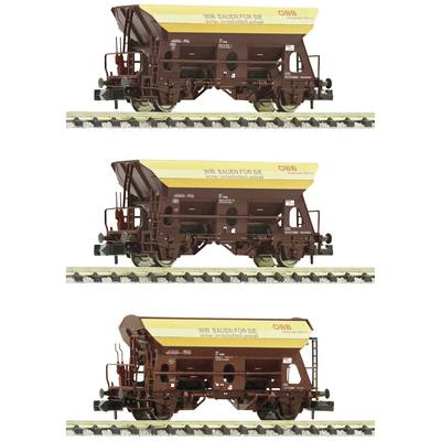 Drei gelbe und braune Güterwaggons der ÖBB auf Eisenbahngleisen, mit der Aufschrift 'Wir bauen für Sie'.