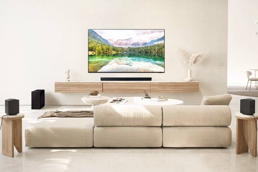 Ein modernes Wohnzimmer mit beige Sofa, großem TV an der Wand und minimalistischem Dekor. Naturbild wird auf dem Fernseher angezeigt.