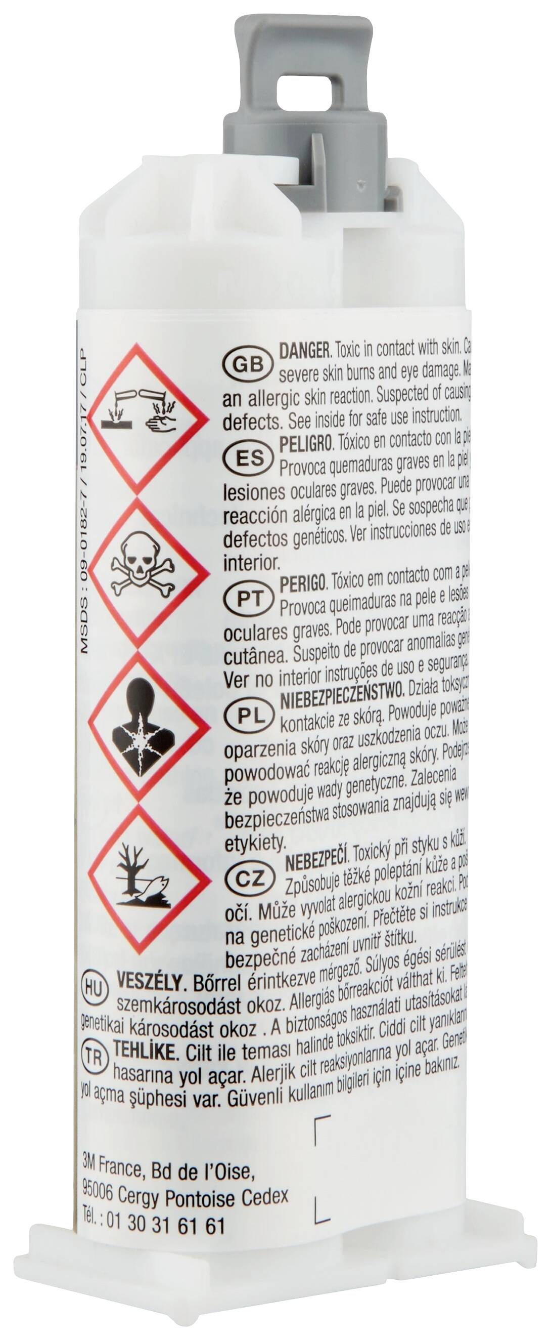 Kleiner Behälter mit Gefahrensymbolen und Warnhinweisen in mehreren Sprachen, einschließlich Totenkopf-Symbol.