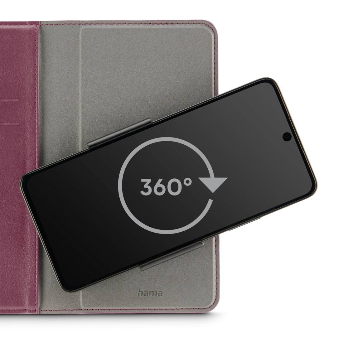 Smartphone in grauer Hülle mit '360°'-Symbol auf dem Bildschirm, möglicherweise drehbar, auf einer rosa Unterlage liegend.