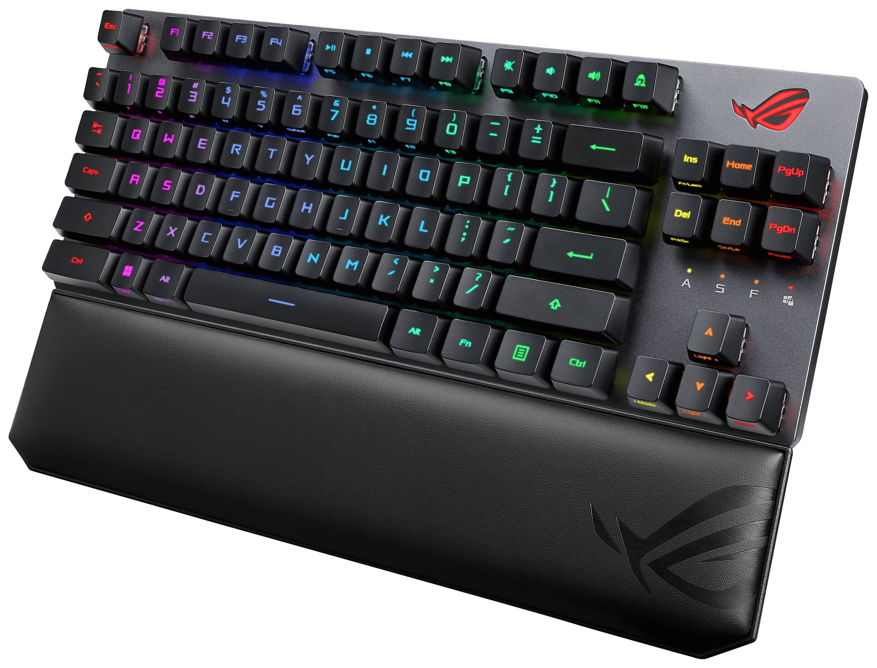 Schwarze Gaming-Tastatur mit RGB-Beleuchtung und abnehmbarer Handballenauflage, Markenlogo oben rechts, Tasten leuchten in Regenbogenfarben.
