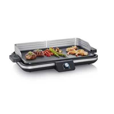 Ein elektrischer Tischgrill mit Steak, Paprika, Spargel, Pilzen und Garnelen auf der Grillfläche. Der Grill hat einen Drehknopf.