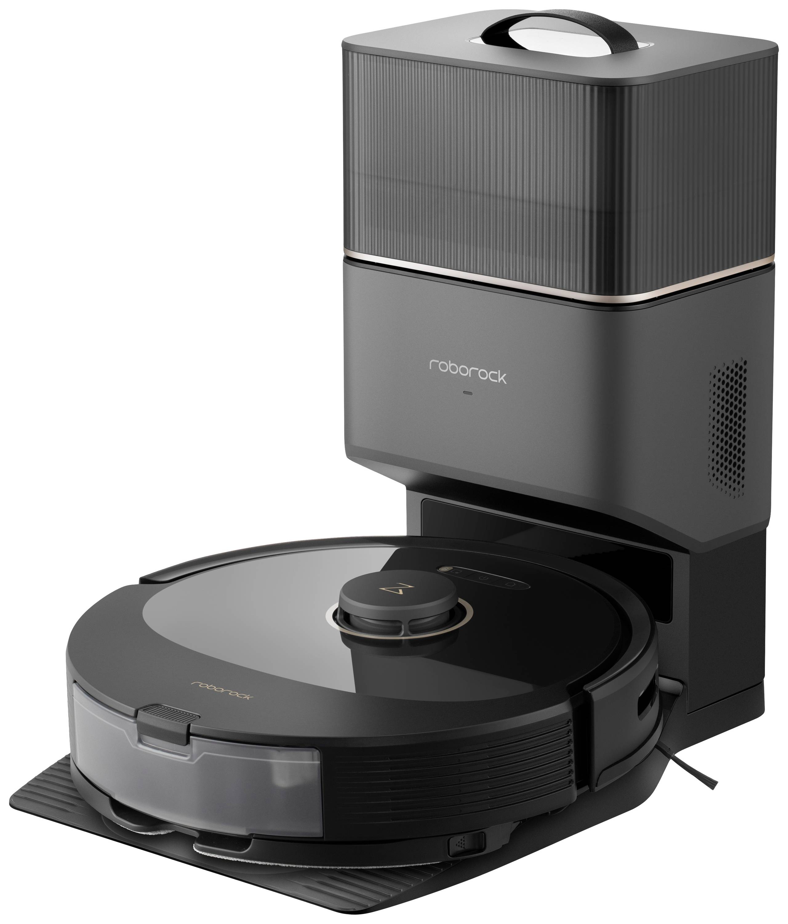 'Dunkler Saugroboter in Ladestation mit glänzender Oberfläche und runden Knöpfen. Er steht auf einem glatten, reflektierenden Boden.'