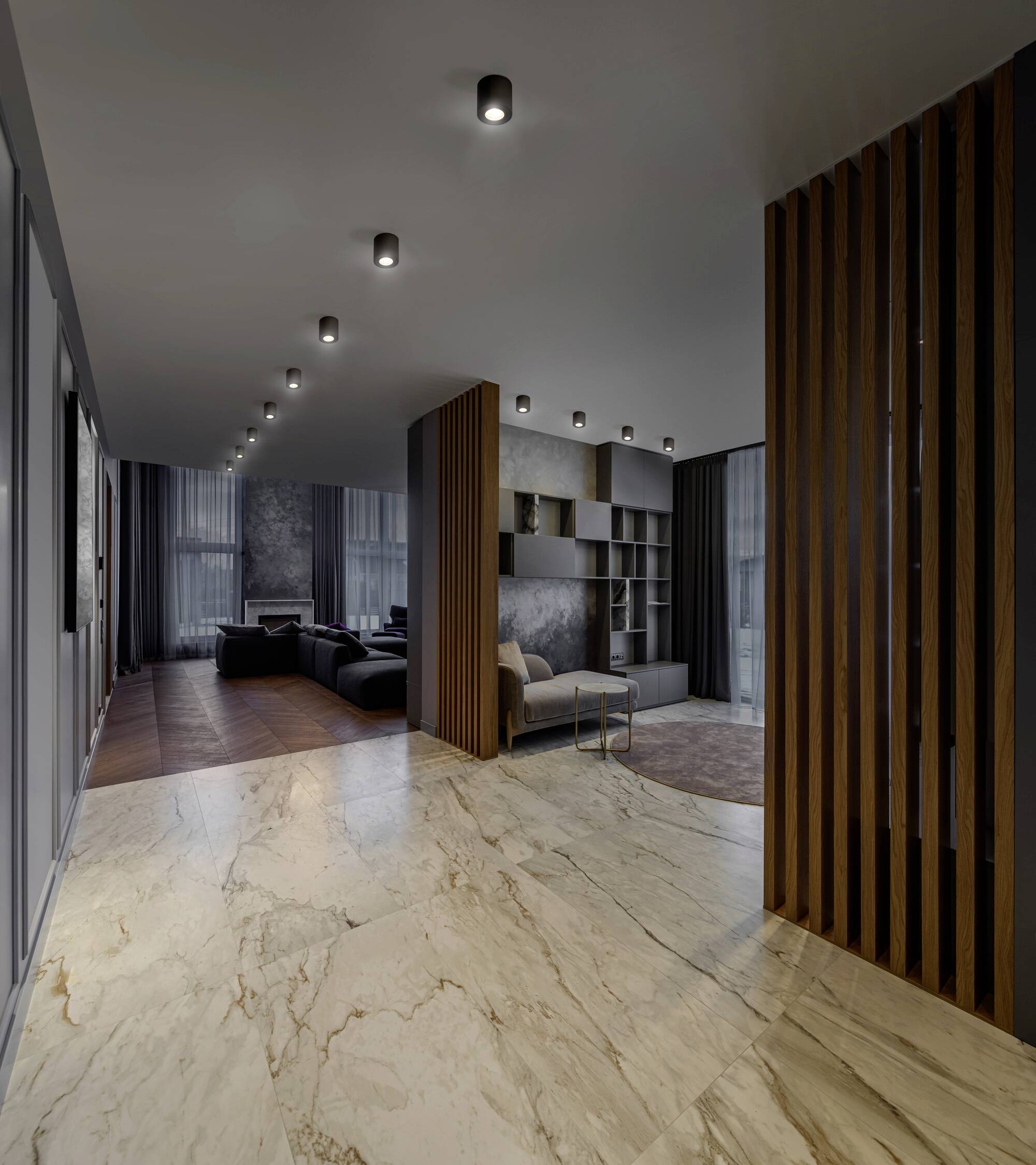 Gemütliches Wohnzimmer mit dunklen Sofas, modernem Kamin und Holzdekor in einem offenen Grundriss. Belebendes Licht-Design.