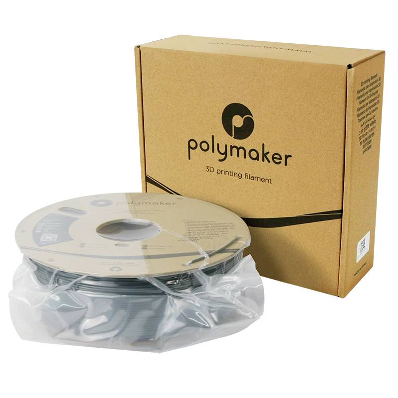 Eine Rolle graues 3D-Drucker-Filament neben einem Karton mit dem Aufdruck 'Polymaker 3D printing filament'.