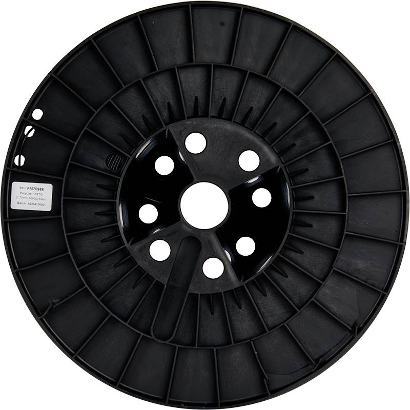 Leere, schwarze Kunststoffspule für Filament. Großes, rundes Design mit sechs Löchern.