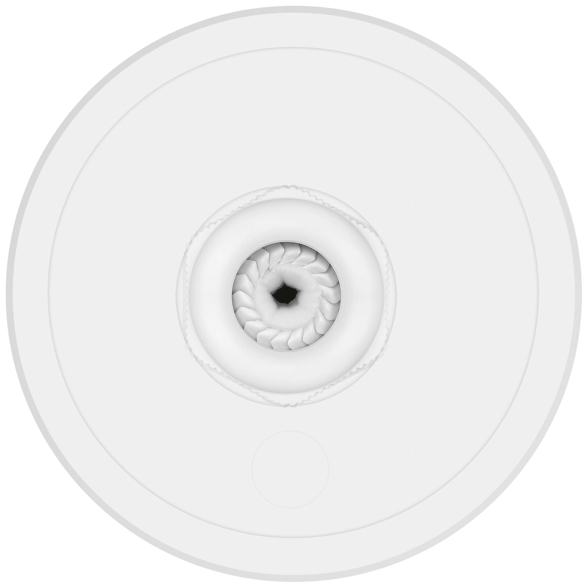 Ein kreisrunder, wirbelförmiger Abfluss in einem weißen Waschbecken. Der Abfluss ist mittig platziert und zeigt spiralförmige Muster.