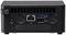 Rückseite eines Mini-PCs mit HDMI-, USB-, Ethernet- und Stromanschlüssen. Lüftungsschlitze oben, schwarzes Gehäuse.