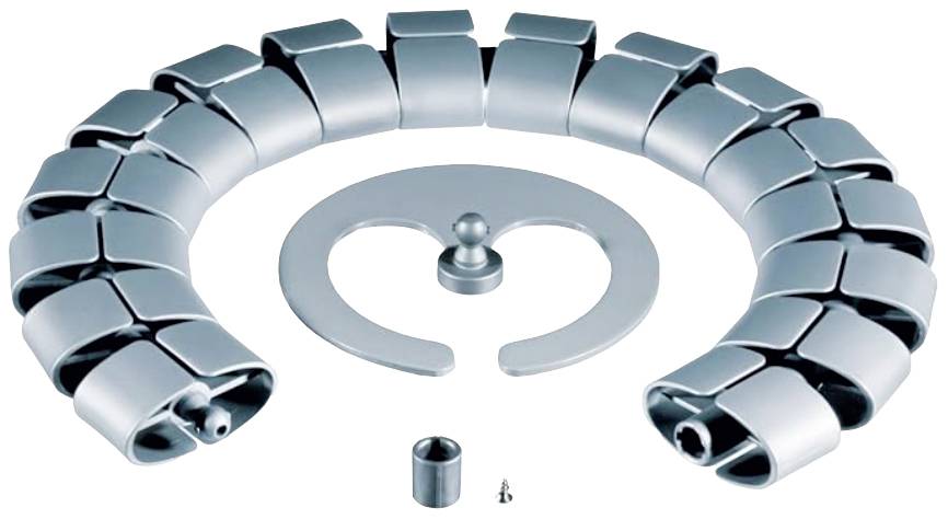 Eine zusammengesetzte, metallische Struktur in Spiralform, bestehend aus rechteckigen Elementen, liegt kreisförmig auf einem Tisch.