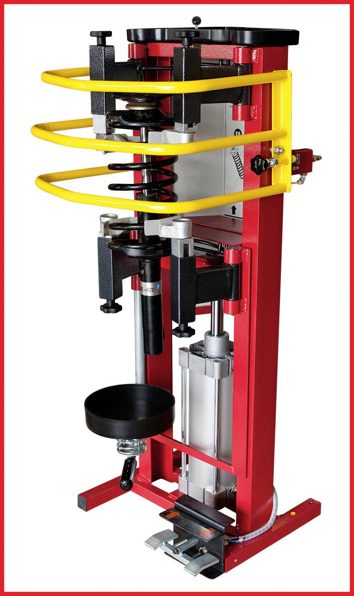 Eine rote und gelbe vertikale Maschine zur Federzusammenstellung. Sie hat hydraulische Komponenten und Metallgestänge.